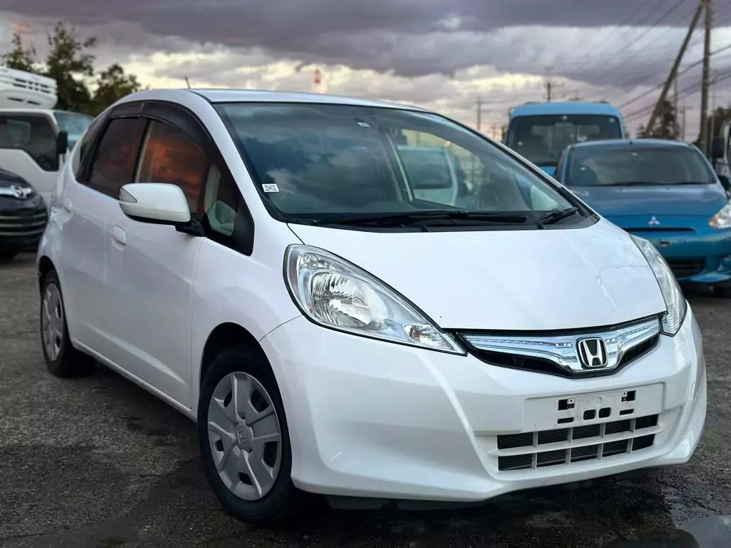white honda fit in evening time